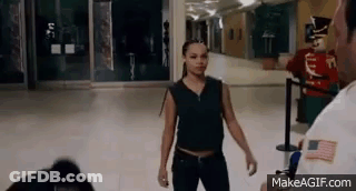 Woman Standing In Hallway With Security Guard GIF