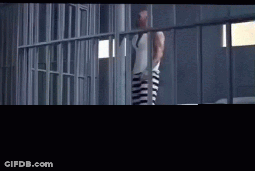 Woman Standing In Jail Cell GIF