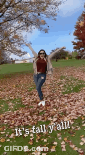 Woman Standing In Leaf Field With Arms Up GIF