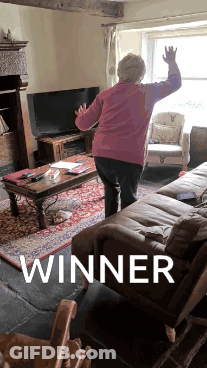 Woman Standing In Living Room With Winner GIF