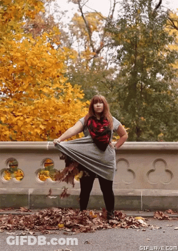 Woman Standing In Pile Of Leaves GIF