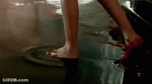 Woman Standing In Pool Of Blood GIF