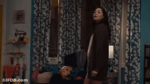 Woman Standing In Room With Lamp GIF