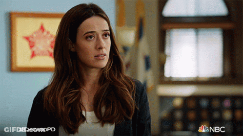 Woman Standing In Room With NBC Logo GIF