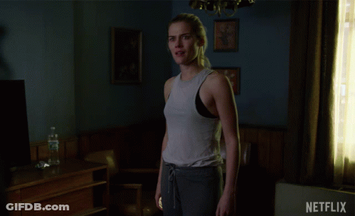 Woman Standing In Room With Netflix Logo GIF