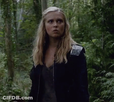 Woman Standing In Woods Wearing Black Jacket GIF