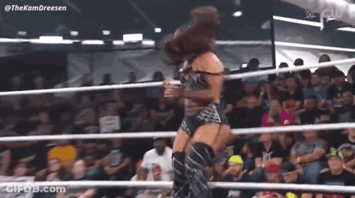 Woman Standing In Wrestling Ring Before Crowd GIF