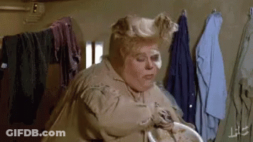 Woman Standing Near Clothes Rack GIF