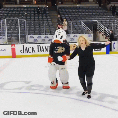 Woman Standing Next To Duck Mascot GIF
