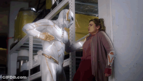 Woman Standing Next To Man In Superhero Costume GIF