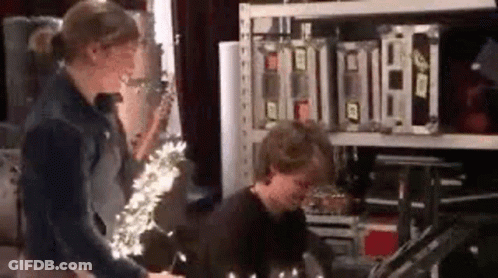 Woman Standing Next To Man In Warehouse GIF