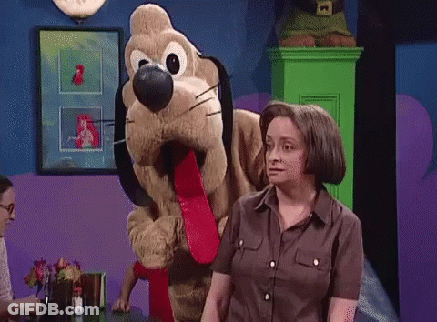 Woman Standing Next To Stuffed Dog With Long Tongue GIF