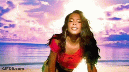 Woman Standing On Beach In Front Of Ocean GIF