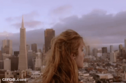 Woman Standing On Building Over City GIF