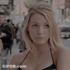Woman Standing On City Street In Black Top GIF