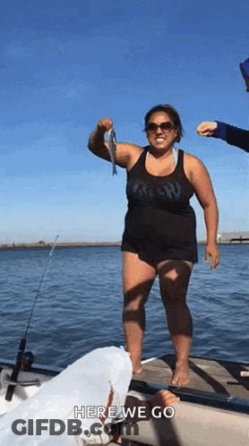 Woman Standing On Dock Holding Fish GIF