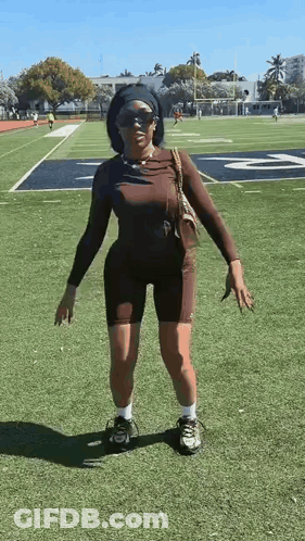 Woman Standing On Football Field GIF
