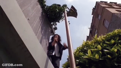 Woman Standing On Ledge Talking On Phone GIF