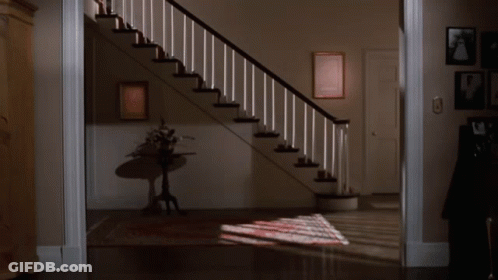 Woman Standing On One Leg In Front Of Staircase GIF