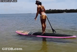 Woman Standing On Paddle Board GIF