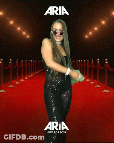 Woman Standing On Red Carpet At Aria Awards GIF
