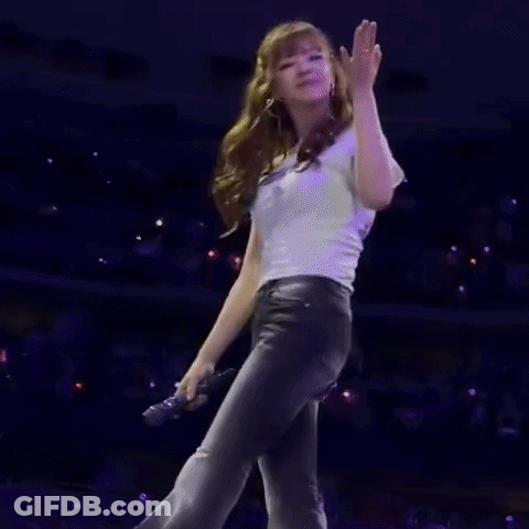 Woman Standing On Stage In Front Of Crowd GIF