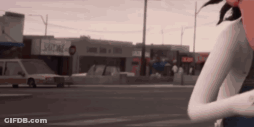 Woman Standing On Street In Front Of Building GIF