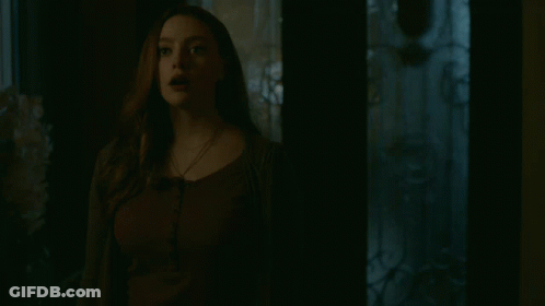 Woman Standing With Eyes Closed In Dark Room GIF