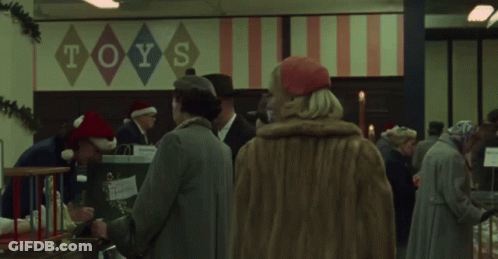 Woman Stands In Front Of Toys Sign GIF