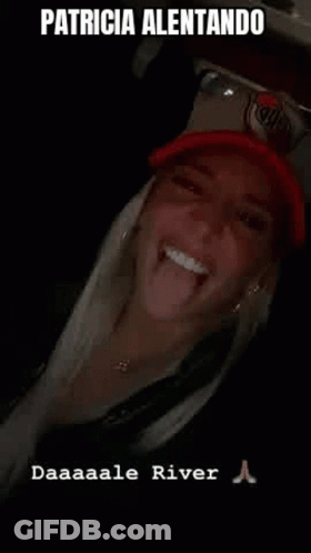 Woman Sticking Tongue Out In Red Hat GIF