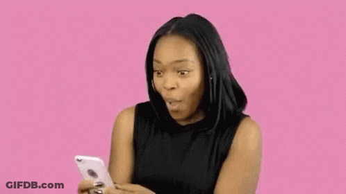 Woman Sticking Tongue Out Looking At Phone GIF