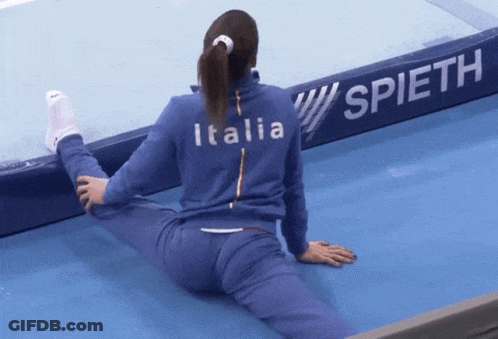 Woman Stretching Legs In Front Of Spieth Sign GIF