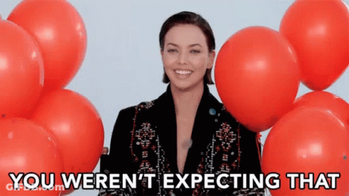 Woman Surrounded By Red Balloons Expecting GIF