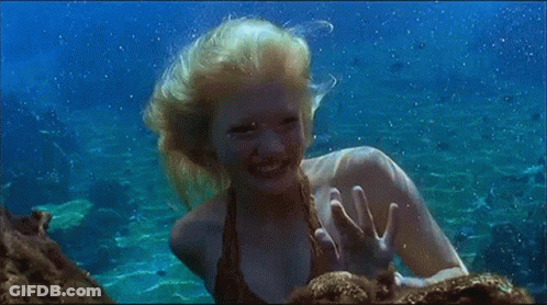 Woman Swimming In Ocean Waving At Camera GIF