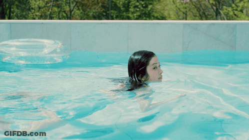 Woman Swimming In Pool With Life Preserver GIF