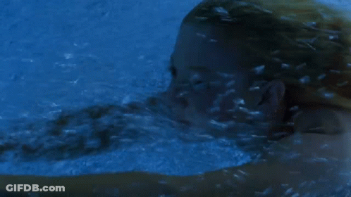 Woman Swimming Underwater In Blue Pool GIF