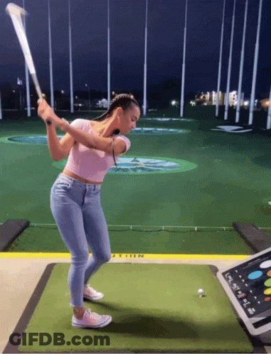 Woman Swinging Golf Club At Golf Ball GIF