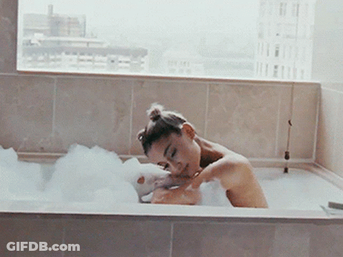 Woman Taking Bath In Bathtub With Bubbles GIF