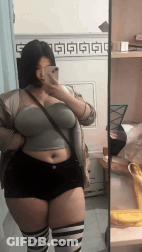Woman Taking Mirror Selfie GIF