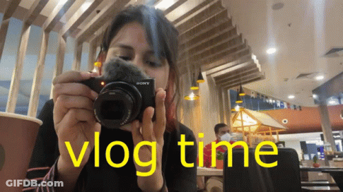 Woman Taking Picture With Sony Camera In Restaurant GIF