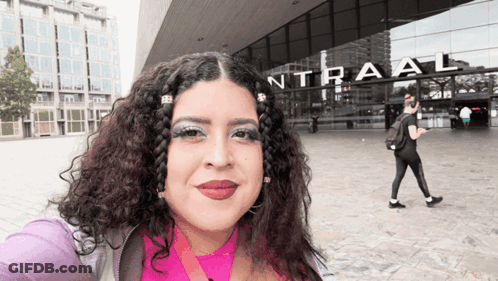 Woman Taking Selfie In Front Of Intraal Building GIF