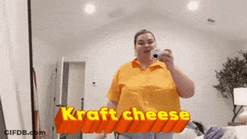 Woman Taking Selfie In Front Of Kraft Cheese Sign GIF