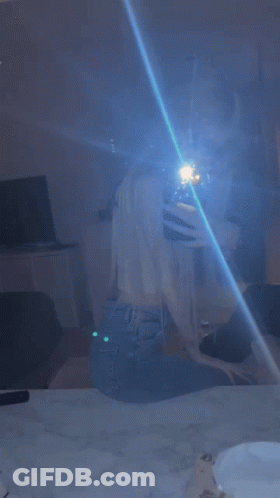 Woman Taking Selfie In Mirror With Blue Light GIF
