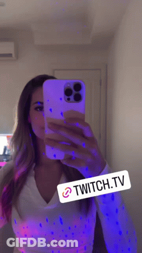 Woman Taking Selfie In Mirror With Glow In The Dark Paint GIF