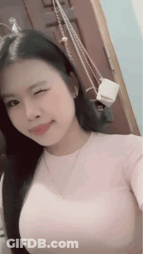 Woman Taking Selfie In Mirror With Purse GIF