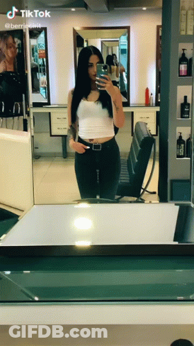 Woman Taking Selfie In Mirror With TikTok GIF