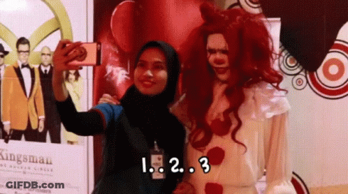 Woman Taking Selfie With Clown Saying Kingsman GIF