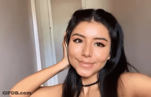 Woman Taking Selfie With Hand To Face GIF