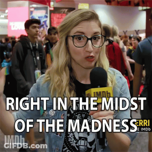 Woman Talking Into Microphone Right In The Midst Of Madness GIF