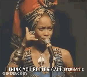 Woman Talking Into Microphone With Head Scarf And Bracelets GIF